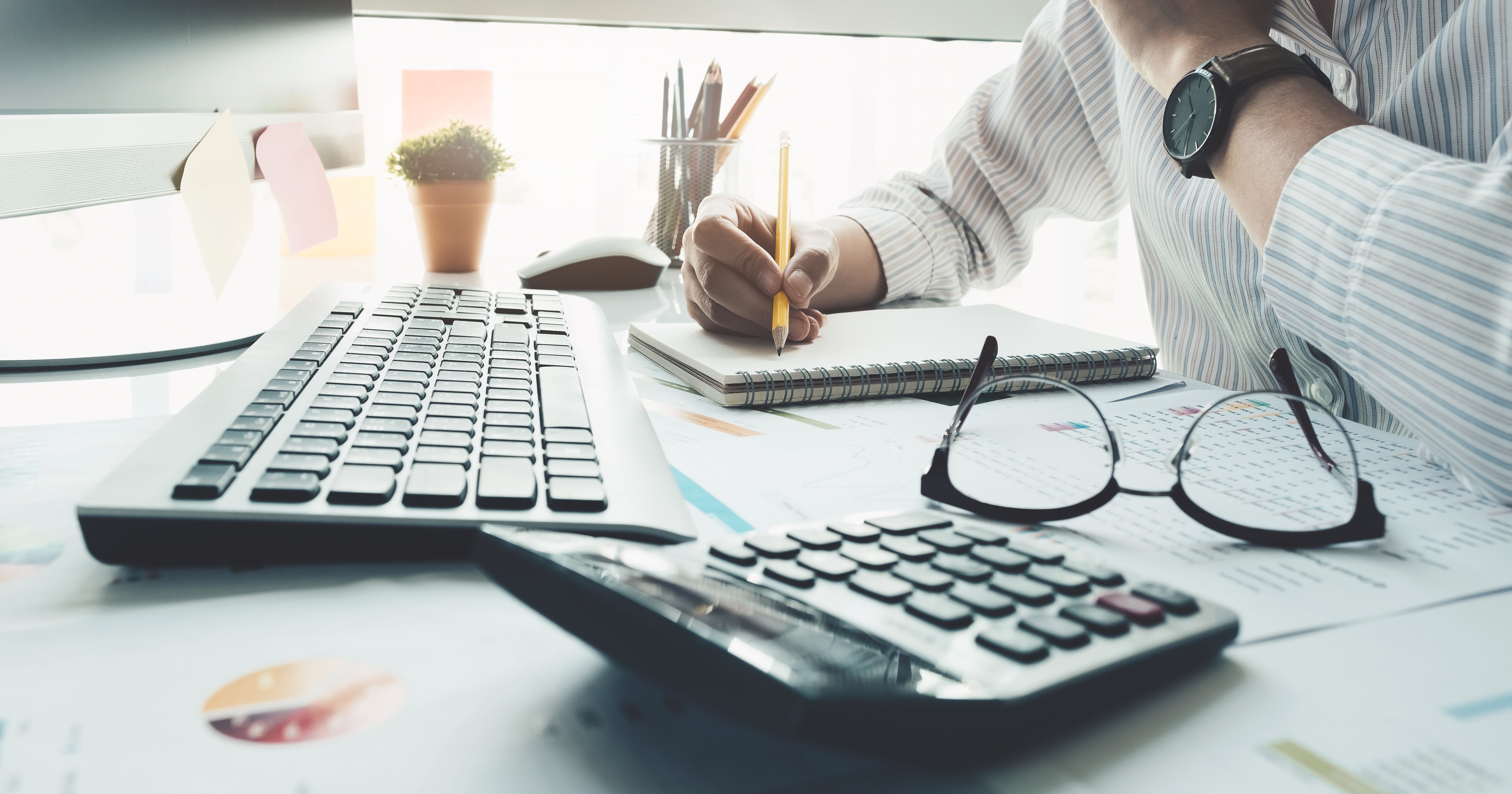 accountant working with calculator and graphs