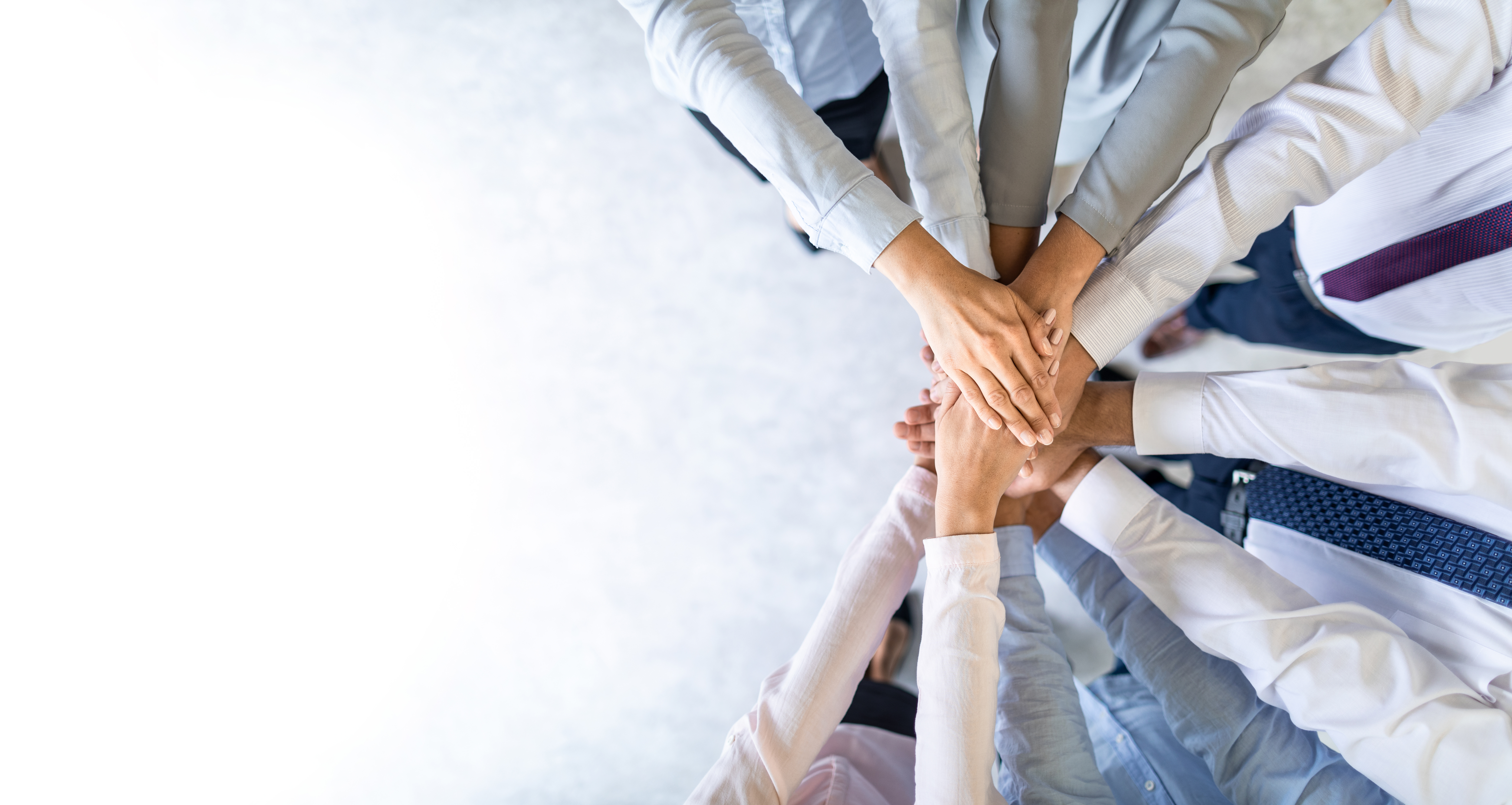 Hands put together in a circle for teamwork