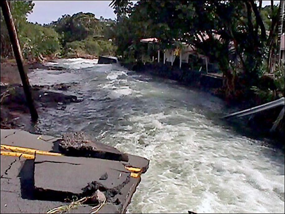 Komohana Avenue, a major thoroughfare in the city of Hilo, was severed by massive flooding at the Alenaio Stream Bridge. Source: NWS